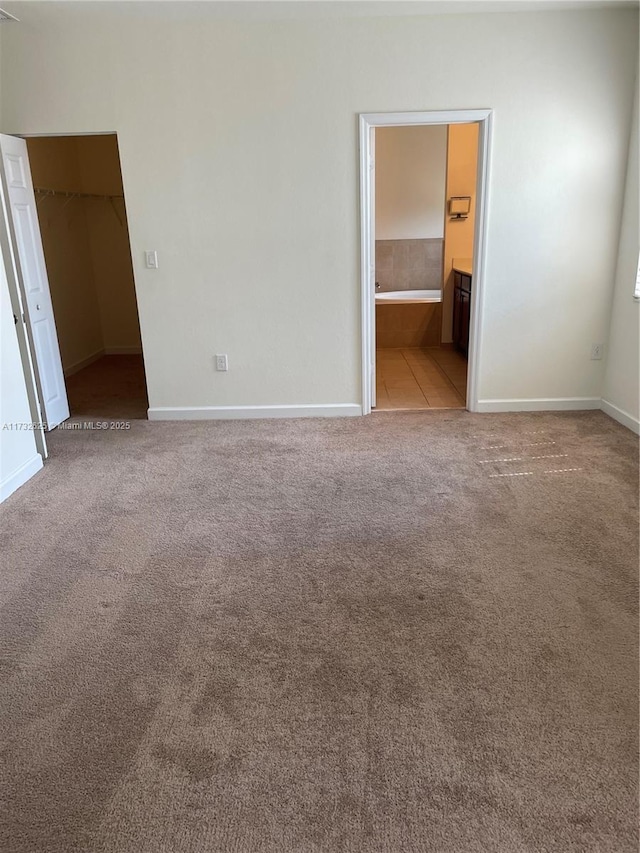15340 SW 176th Ln, Miami, FL 33187 - unfurnished bedroom featuring carpet, a walk in closet, a closet, and connected bathroom