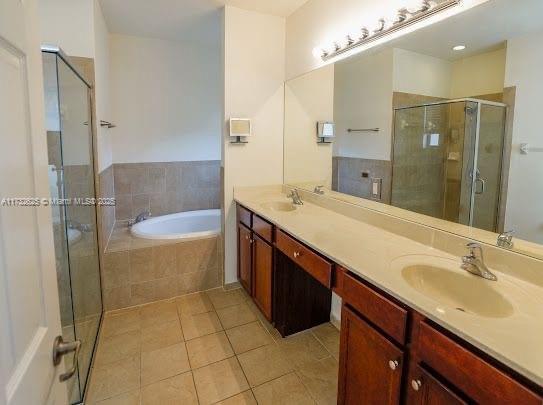 15340 SW 176th Ln, Miami, FL 33187 - bathroom with tile patterned flooring, double vanity, a garden tub, and a stall shower