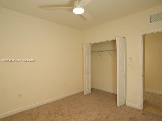 15340 SW 176th Ln, Miami, FL 33187 - unfurnished bedroom with light carpet, a closet, and a ceiling fan