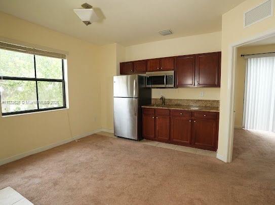 15340 SW 176th Ln, Miami, FL 33187 - kitchen featuring stainless steel appliances, light colored carpet, and healthy amount of natural light