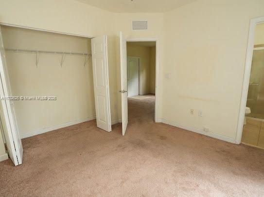 15340 SW 176th Ln, Miami, FL 33187 - unfurnished bedroom with light carpet, a closet, and ensuite bath