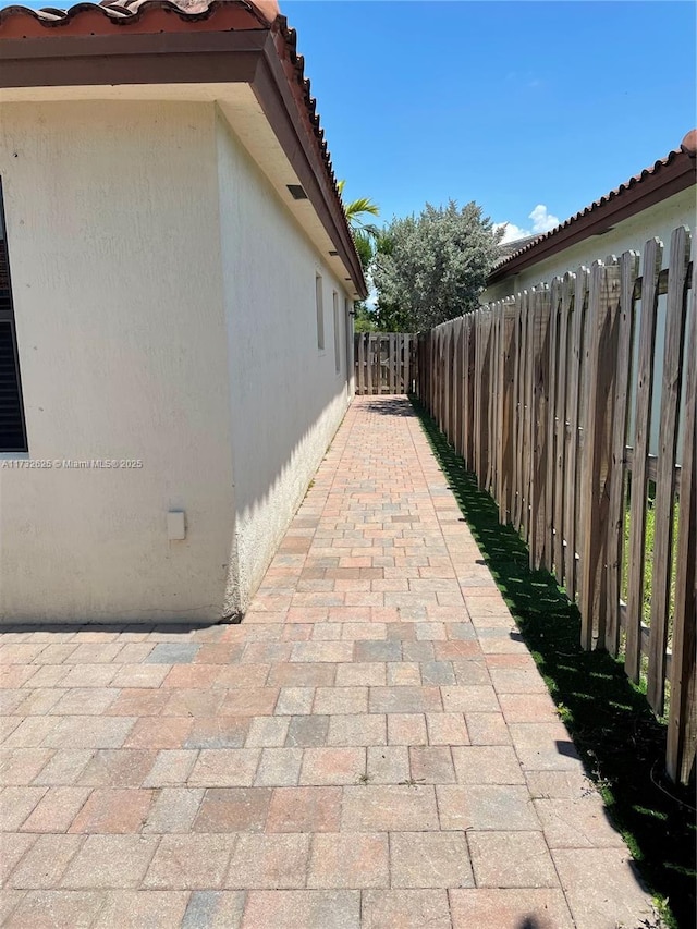 15340 SW 176th Ln, Miami, FL 33187 - view of property exterior featuring a tiled roof, stucco siding, and a patio area