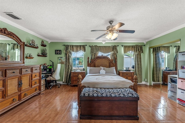 bedroom with tile patterned floors, visible vents, multiple windows, and ornamental molding