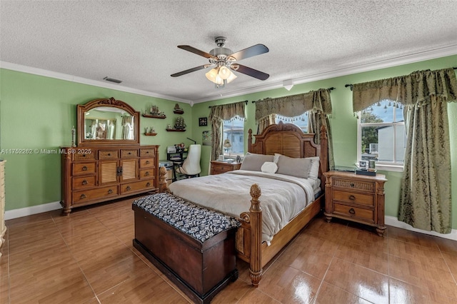 bedroom with visible vents, a textured ceiling, and crown molding