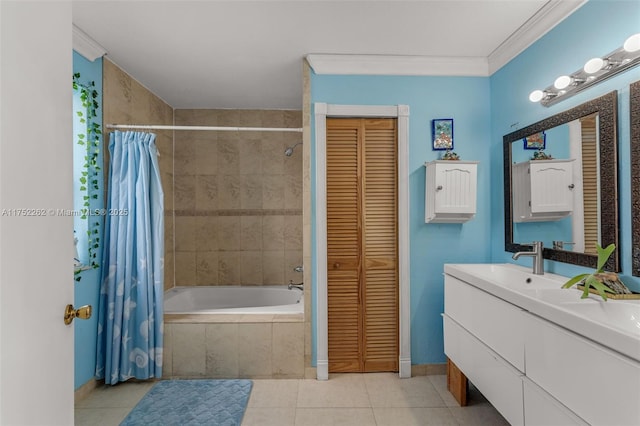 bathroom featuring tile patterned floors, crown molding, a closet, tiled shower / bath, and a sink