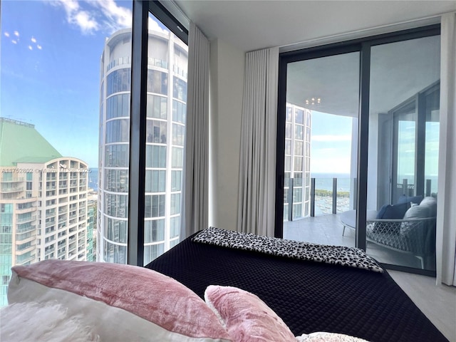 bedroom featuring access to outside and floor to ceiling windows