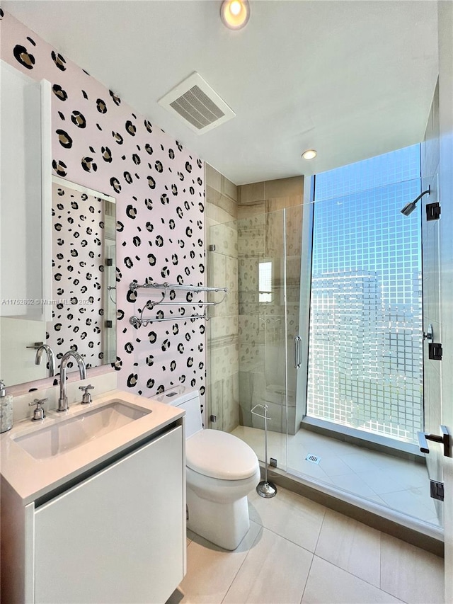 full bathroom with a stall shower, plenty of natural light, visible vents, toilet, and vanity