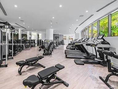 exercise room featuring wood finished floors, visible vents, and recessed lighting