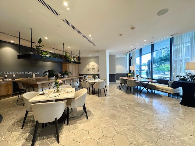 dining room with expansive windows, light tile patterned floors, and visible vents