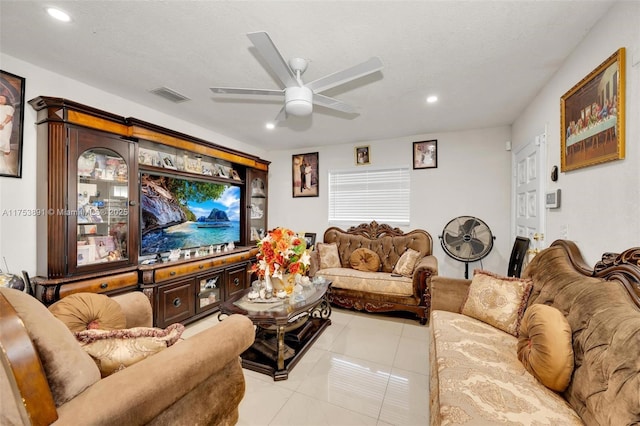 living room with a textured ceiling, ceiling fan, light tile patterned flooring, recessed lighting, and visible vents