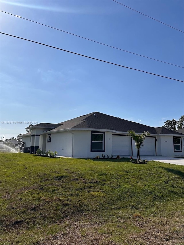 view of home's exterior featuring a garage, a yard, and stucco siding