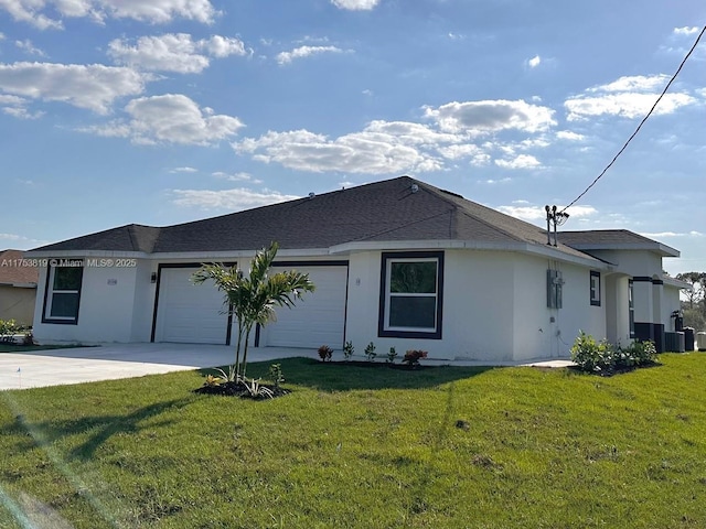 exterior space featuring an attached garage, driveway, a lawn, and stucco siding