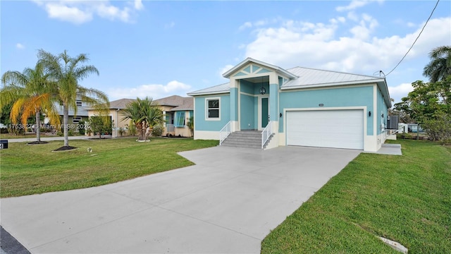 view of front of home with metal roof, an attached garage, concrete driveway, stucco siding, and a front lawn