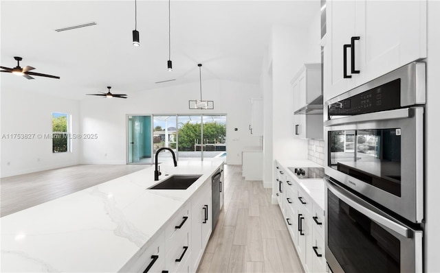 kitchen with visible vents, backsplash, open floor plan, stainless steel double oven, and a sink