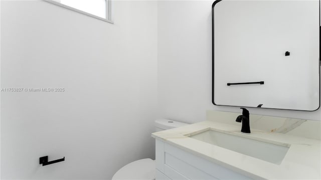 bathroom with vanity and toilet