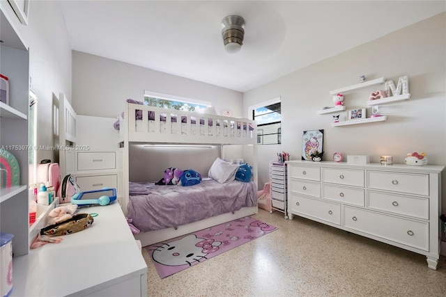 bedroom with light speckled floor and a ceiling fan