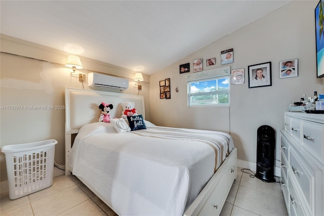 bedroom featuring lofted ceiling, an AC wall unit, light tile patterned flooring, and baseboards