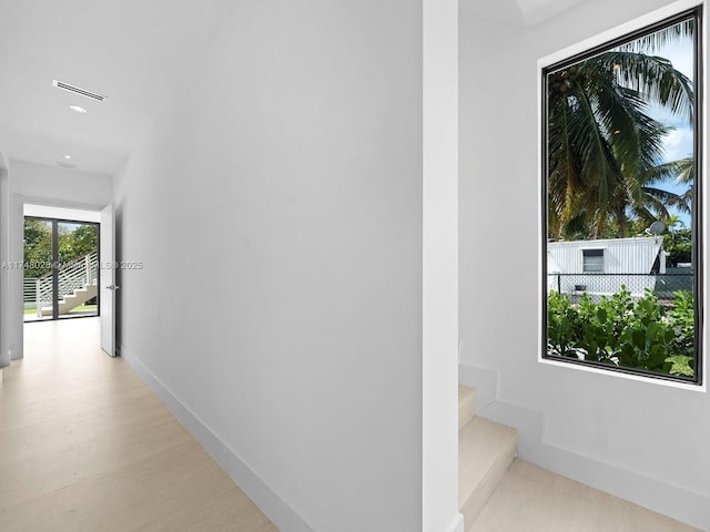 hall with stairway and recessed lighting