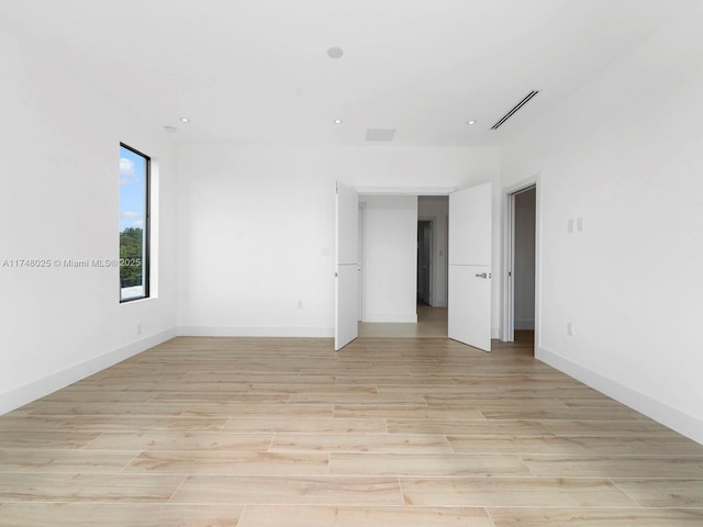 empty room featuring light wood finished floors and recessed lighting