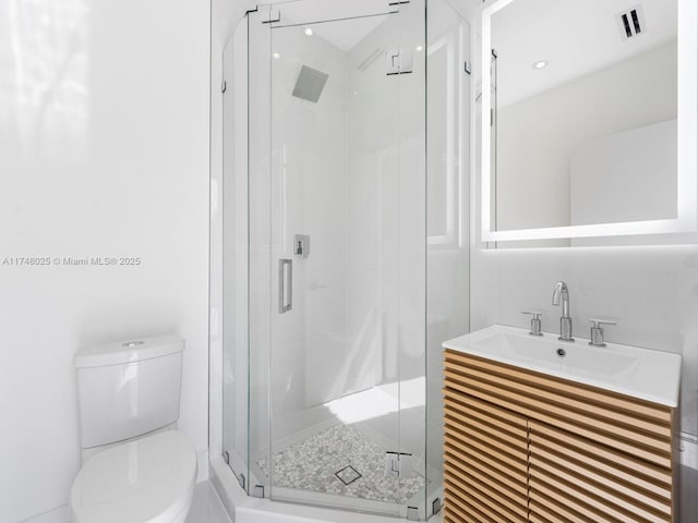 bathroom featuring a shower stall and vanity