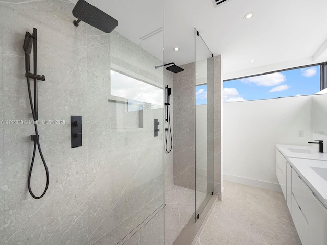 full bath featuring a walk in shower, double vanity, and recessed lighting