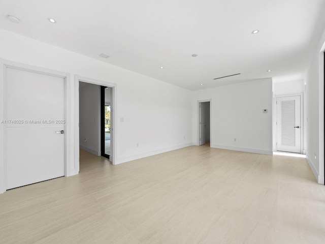 empty room with recessed lighting and light wood finished floors