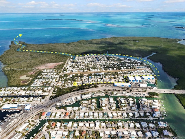 aerial view of property and surrounding area featuring a large body of water