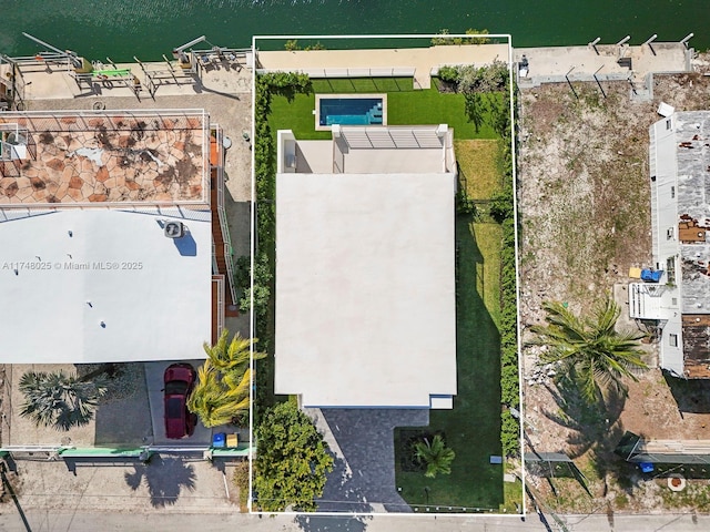 aerial view of property and surrounding area featuring property boundaries highlighted and a nearby body of water