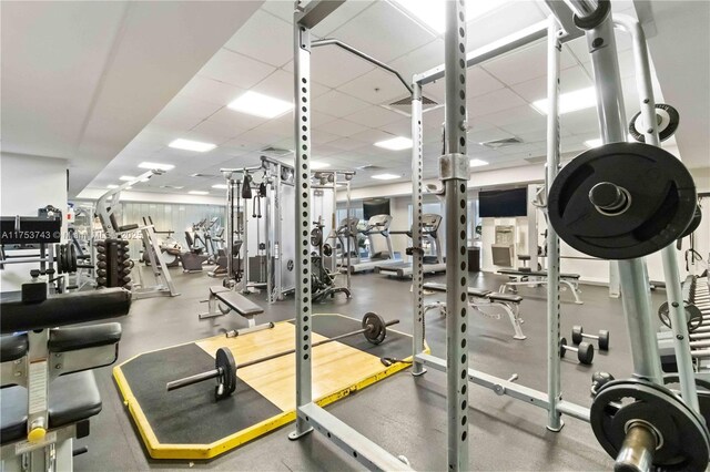 exercise room featuring a drop ceiling