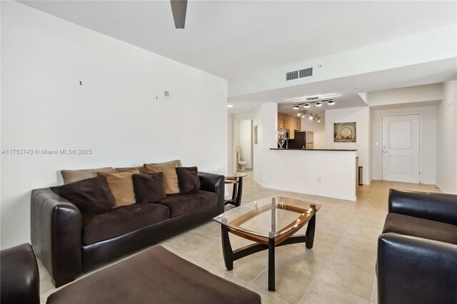 living room with visible vents and track lighting
