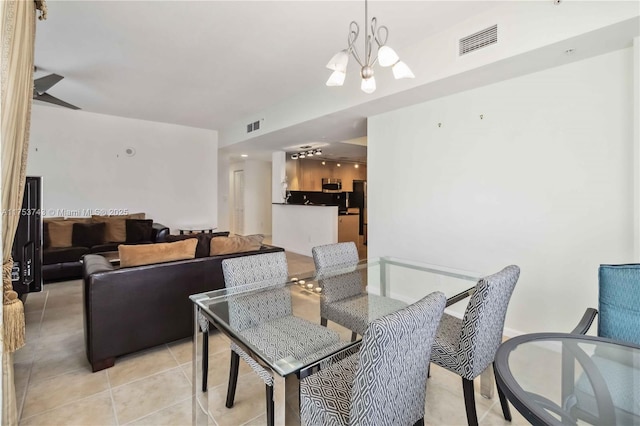 dining area featuring visible vents, ceiling fan with notable chandelier, and light tile patterned flooring