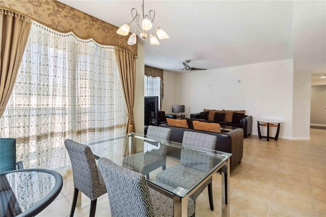 dining space with tile patterned floors, a notable chandelier, and baseboards