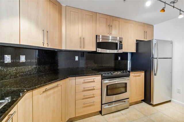 511 SE 5th Ave Unit 1214, Fort Lauderdale, FL 33301 - kitchen with stainless steel appliances, light brown cabinetry, tasteful backsplash, light tile patterned floors, and dark stone counters