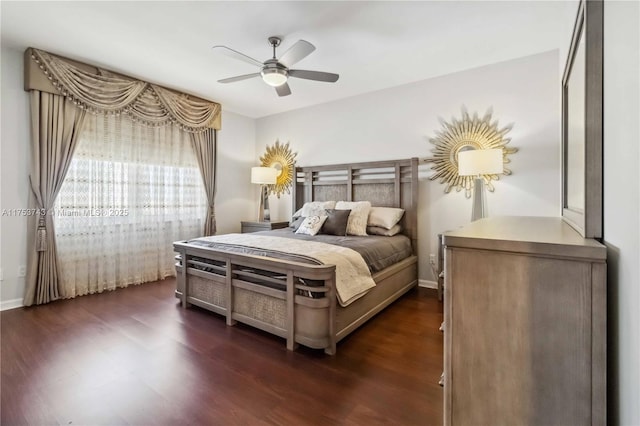 bedroom featuring dark wood-style floors, baseboards, and a ceiling fan