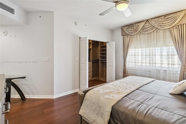 bedroom with visible vents, baseboards, a closet, ceiling fan, and wood finished floors