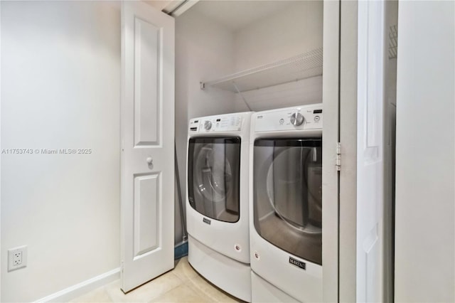 laundry area featuring laundry area, light tile patterned floors, baseboards, and washing machine and dryer