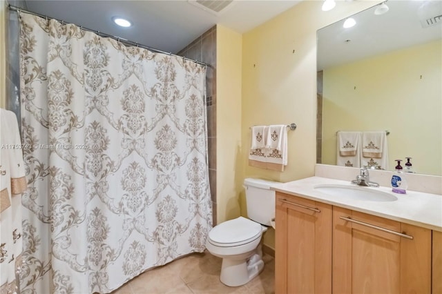 bathroom featuring visible vents, toilet, vanity, and tile patterned floors