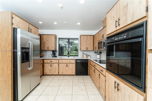 kitchen featuring backsplash, light tile patterned flooring, black appliances, a sink, and recessed lighting