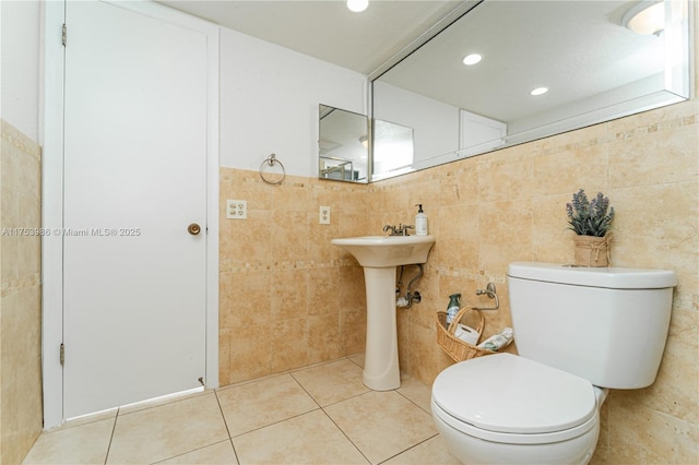 bathroom with recessed lighting, tile walls, toilet, and tile patterned floors