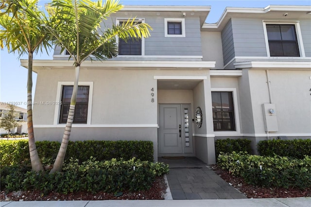 property entrance featuring stucco siding