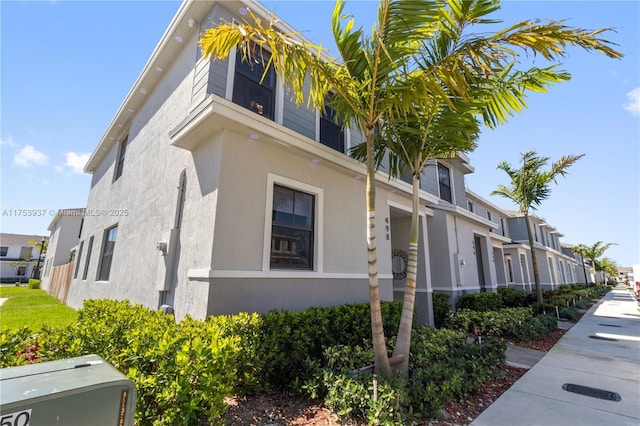 view of side of property featuring a residential view and stucco siding