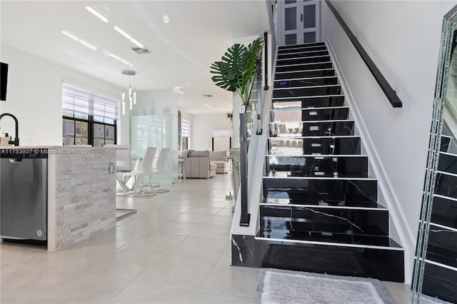 staircase with visible vents and tile patterned floors