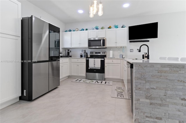 kitchen with stainless steel appliances, white cabinets, and a sink