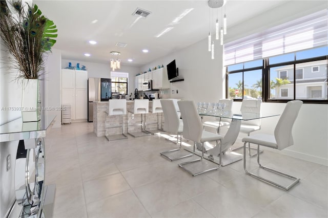 dining room featuring light tile patterned floors, baseboards, visible vents, and recessed lighting