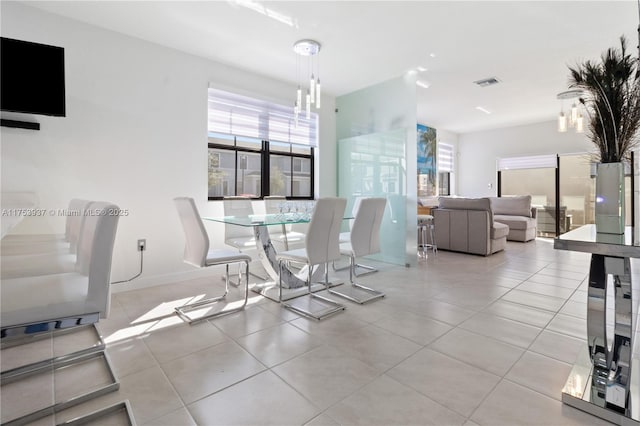 tiled dining room featuring visible vents