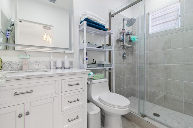 full bath featuring a stall shower, vanity, and toilet