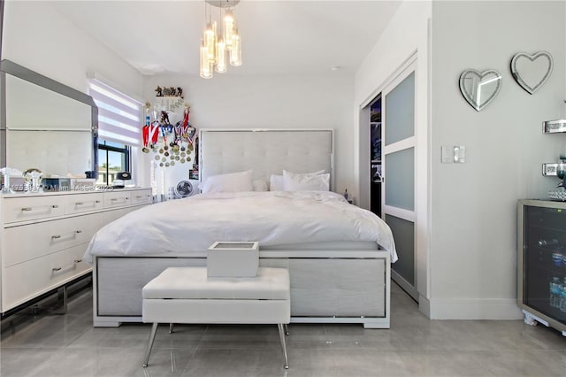 bedroom with an inviting chandelier and baseboards