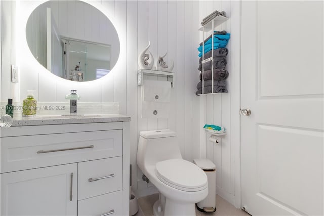 half bathroom with toilet and vanity