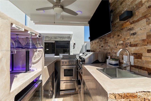 view of patio / terrace featuring ceiling fan, an outdoor kitchen, and a sink