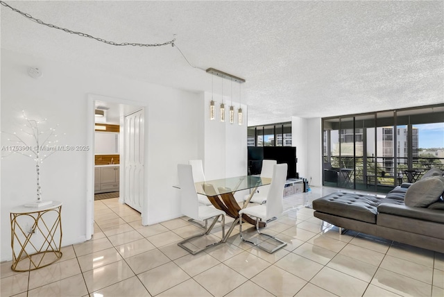 dining room with light tile patterned floors, a textured ceiling, and floor to ceiling windows